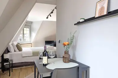 a bedroom with a bed and a table with wine glasses at Apartman Paradise Slavija Dos in Belgrade