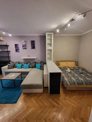a living room with a bed and a couch at Lucky Apartments New Belgrade in Belgrade