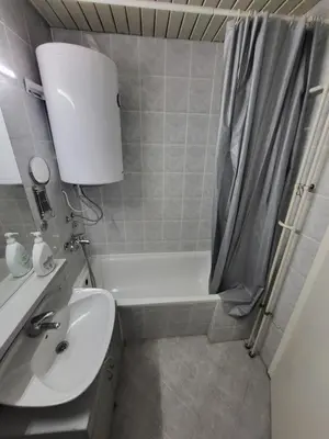 a bathroom with a sink and a toilet and a bath tub at Lucky Apartments New Belgrade in Belgrade