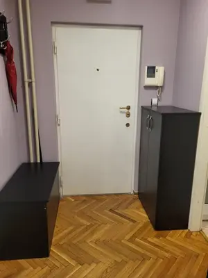 a room with a white door and a wooden floor at Lucky Apartments New Belgrade in Belgrade