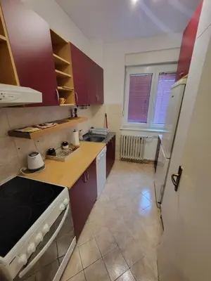 a kitchen with purple cabinets and a white refrigerator at Lucky Apartments New Belgrade in Belgrade
