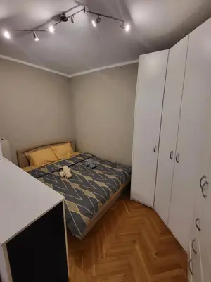 a small bedroom with a bed and a desk at Lucky Apartments New Belgrade in Belgrade