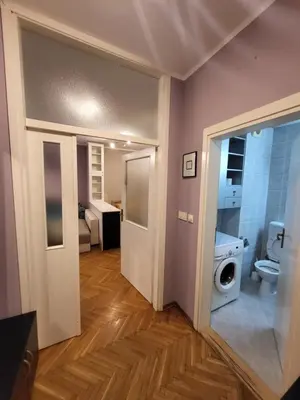 a bathroom with a toilet and a washing machine at Lucky Apartments New Belgrade in Belgrade