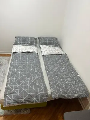 a bed in a room with two pillows on it at Aurora Apartmani Indjija in Inđija