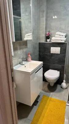 a bathroom with a white sink and a toilet at Apartman Pazova in Stara Pazova