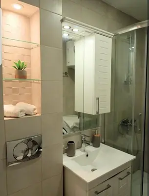 a bathroom with a sink and a mirror at Rose City Centre Apartment in Belgrade