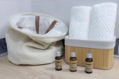 two bottles of essential oils next to a bag of toilet paper at Central Nusic apartment in Belgrade