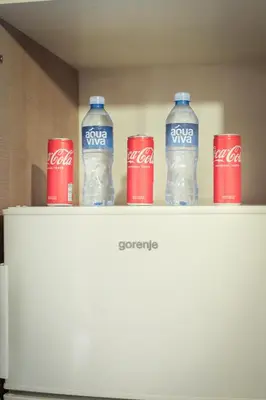 four coca cola bottles on top of a refrigerator at Central Nusic apartment in Belgrade