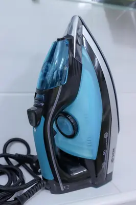 a blue and black iron sitting on top of a counter at Central Nusic apartment in Belgrade