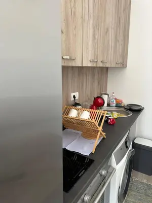a kitchen with a counter with a basket of food at lovely studio apartment in Belgrade