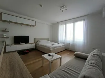 a living room with a couch and a bed at Stela apartment in Belgrade