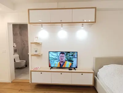 a television sitting on a table in a bedroom at Stela apartment in Belgrade