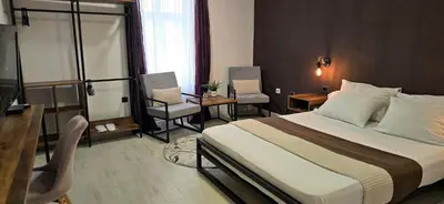 a hotel room with a bed and two chairs at TeaBG in Belgrade