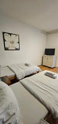 a room with two beds and a flat screen tv at TeaBG in Belgrade