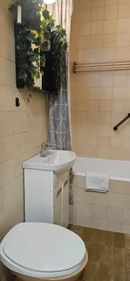 a bathroom with a toilet and a sink and a tub at TeaBG in Belgrade