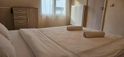 a bedroom with a large bed with two pillows on it at TeaBG in Belgrade