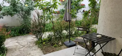 a patio with a table and two chairs and an umbrella at TeaBG in Belgrade