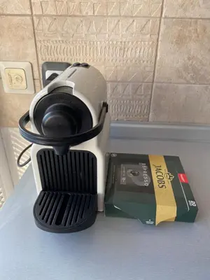 a camera sitting on a table next to a book at Prostrani dupleks u istorijskom centru grada Anna in Belgrade