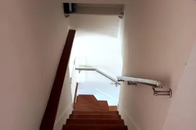 a staircase in a building with a stair railing at Prostrani dupleks u istorijskom centru grada Anna in Belgrade