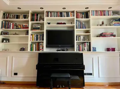 a living room with a tv and a piano at Prostrani dupleks u istorijskom centru grada Anna in Belgrade