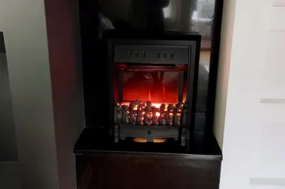 a stove with a fire inside of it at Prostrani dupleks u istorijskom centru grada Anna in Belgrade
