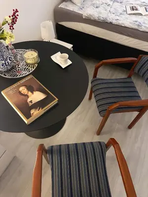 a room with a table and chairs and a bed at The Horse Monument Hostel in Belgrade