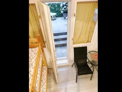 a room with a staircase and a table and a window at The Horse Monument Hostel in Belgrade