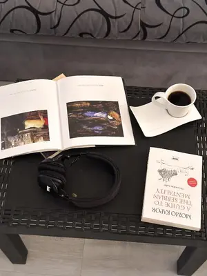 a table with a book and a cup of coffee at The Horse Monument Hostel in Belgrade