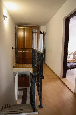 a hallway with a spiral staircase in a house at Sobe i apartmani Djordjevic in Mladenovac