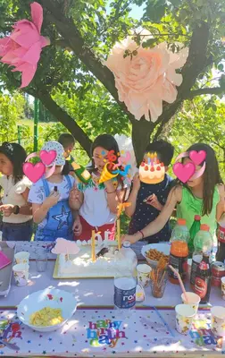 a group of children standing around a table with a birthday cake at Sobe i apartmani Djordjevic in Mladenovac