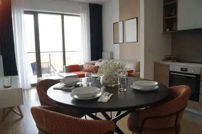 a living room with a black table and chairs at Belgrade Boutique Verde in Belgrade