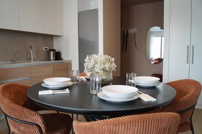 a dining room table with a black table and chairs at Belgrade Boutique Verde in Belgrade