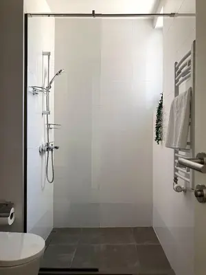 a bathroom with a shower with a toilet and a sink at Belgrade Boutique Verde in Belgrade