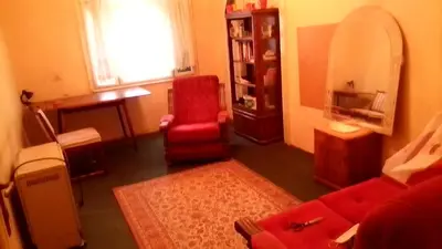a living room with a red couch and a red chair at Teranuovo in Belgrade