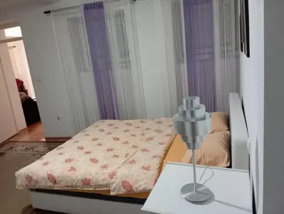 a small bedroom with a bed and a table at Central market plaza Promo price ! in Belgrade