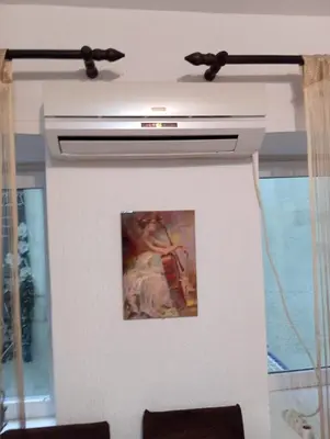 a fireplace in a living room with a painting at Central market plaza Promo price ! in Belgrade