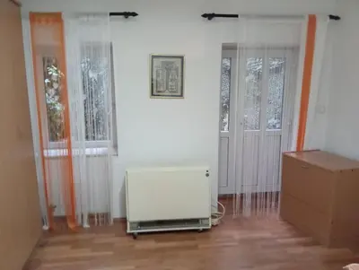 a room with two windows and a white refrigerator at Central market plaza Promo price ! in Belgrade