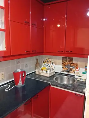 a red kitchen with a sink and red cabinets at Central market plaza Promo price ! in Belgrade