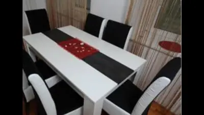 a white table with black chairs and a red and black sidx sidx sidx at Central market plaza Promo price ! in Belgrade