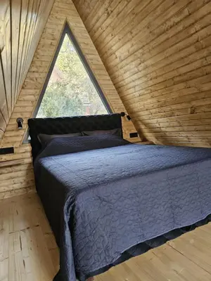 a bed in a room with a large window at Villa SS Black Fruška Gora in Čortanovci