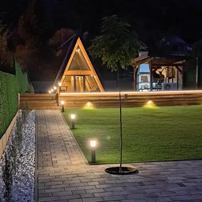 a garden with lights in the grass at night at Villa SS Black Fruška Gora in Čortanovci