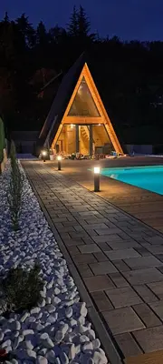 a building with lights in front of a pool at night at Villa SS Black Fruška Gora in Čortanovci