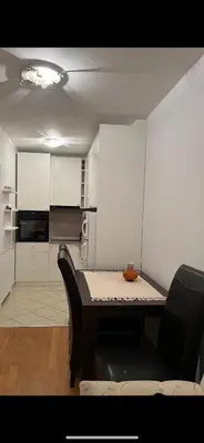 a small kitchen with a table and a chair at La Casa Stan na dan in Belgrade