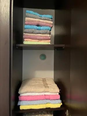 a pile of towels on a shelf in a bathroom at La Casa Stan na dan in Belgrade