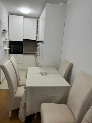 a dining room with a table and chairs at La Casa Stan na dan in Belgrade