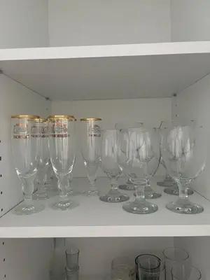 a row of wine glasses sitting on a shelf at La Casa Stan na dan in Belgrade