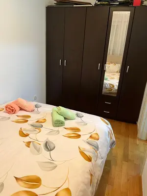 a bedroom with a bed with leaves on it at La Casa Stan na dan in Belgrade