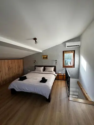 a bedroom with a large white bed and a window at Johnny Apartment in Belgrade