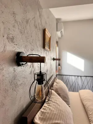 a lantern on a wall next to a bed at Johnny Apartment in Belgrade