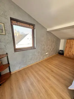 an empty room with a window and a wooden floor at Johnny Apartment in Belgrade